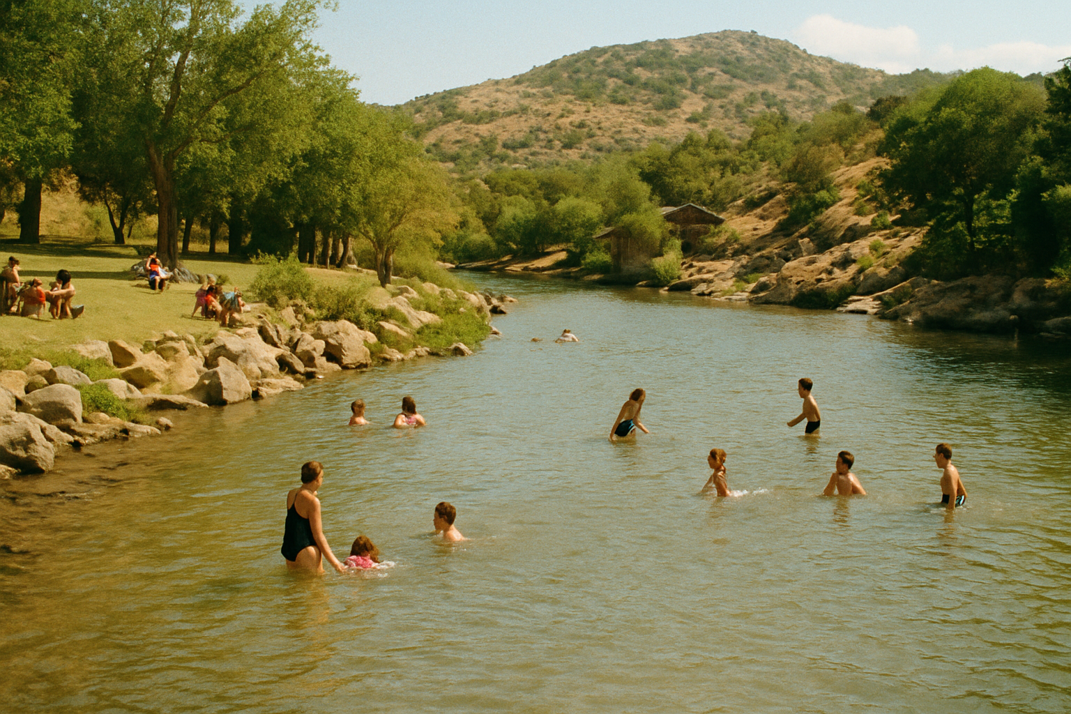 Image of Canon AE-1 Portra 1600 photo with medium grain photographing the river running alongside Medicine Park in Oklahoma with families swimming